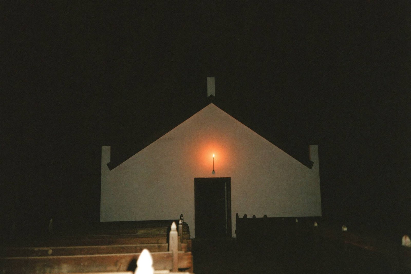 Placeholder — intended image: Candlelit Compline, chapel interior at night, deep shadow